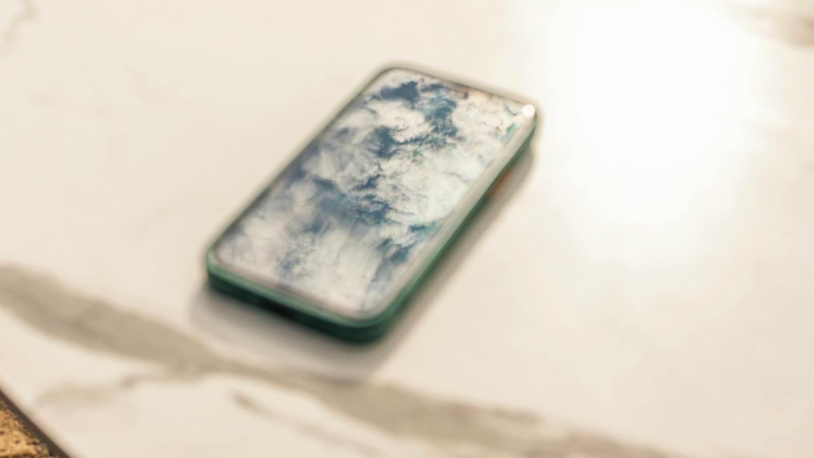 A smartphone lying on a white marble café table